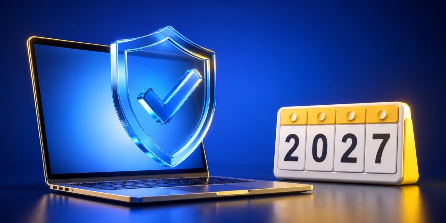 Un portátil con un escudo de seguridad delante de la pantalla y un calendario de mesa con el año 2027